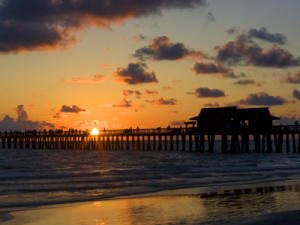 View of the pier at sunset from a Naples Real Estate home
